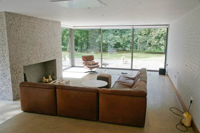 Large sitting room in contemporary country home. Large windows facing onto gardens and lots of natural light.