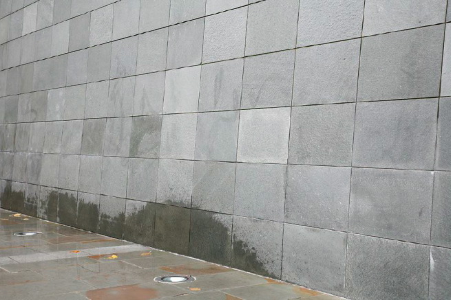 Graphic modern steps with tall slate walls.