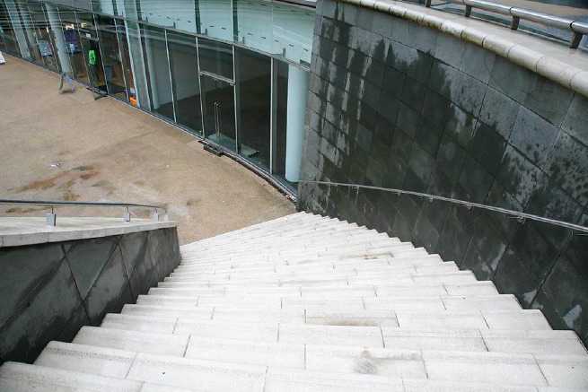 Graphic modern steps with tall slate walls.