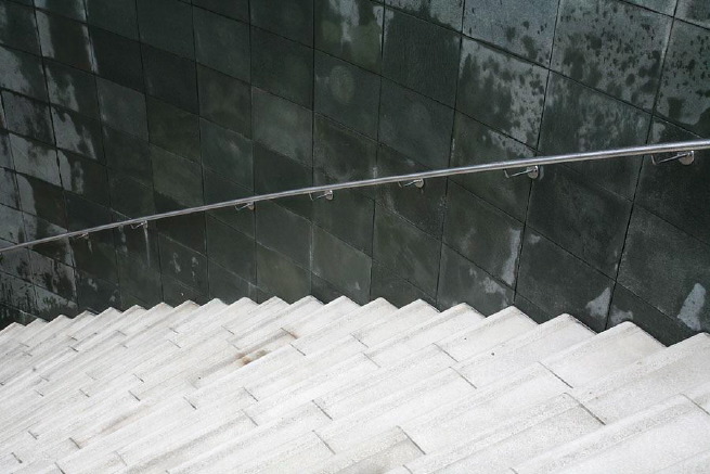 Graphic modern steps with tall slate walls.