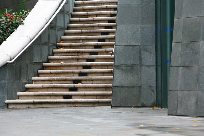Graphic modern steps with tall slate walls.
