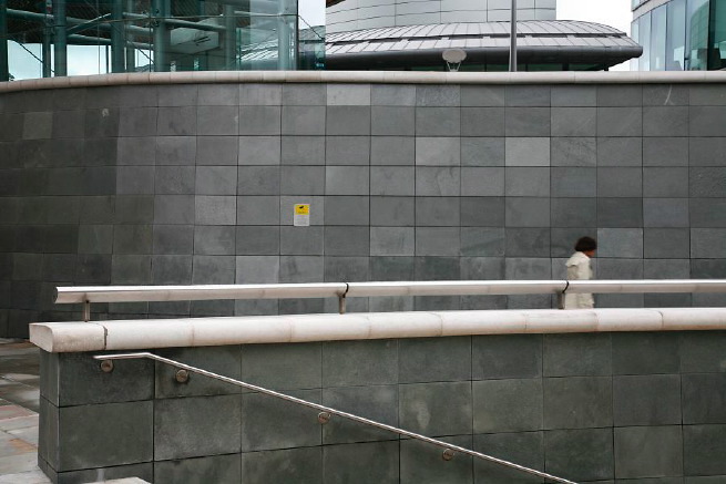 Graphic modern steps with tall slate walls.